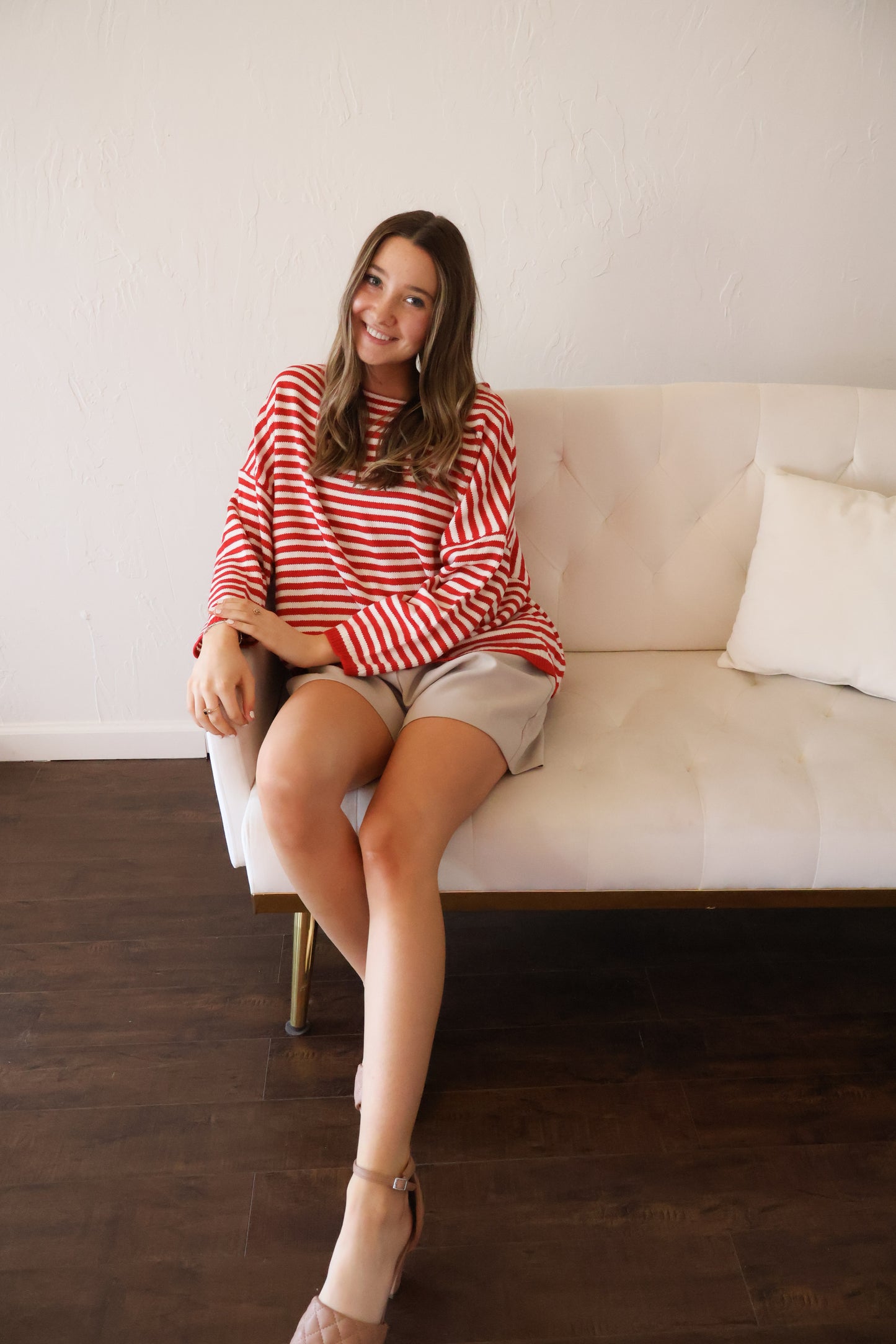 Red and Tan Sweater Sitting Down
