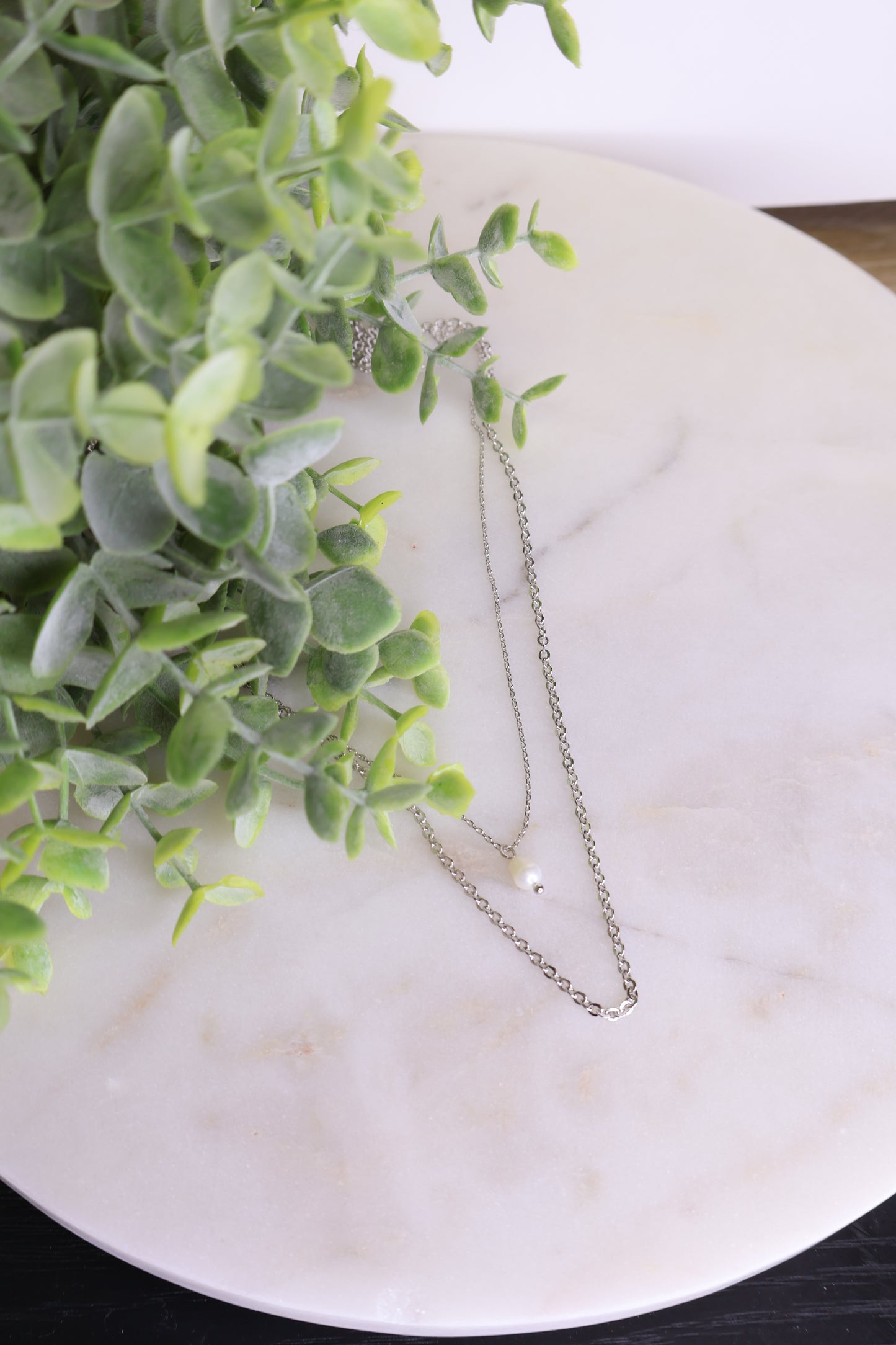 Floating Pearl Necklace on a flat surface