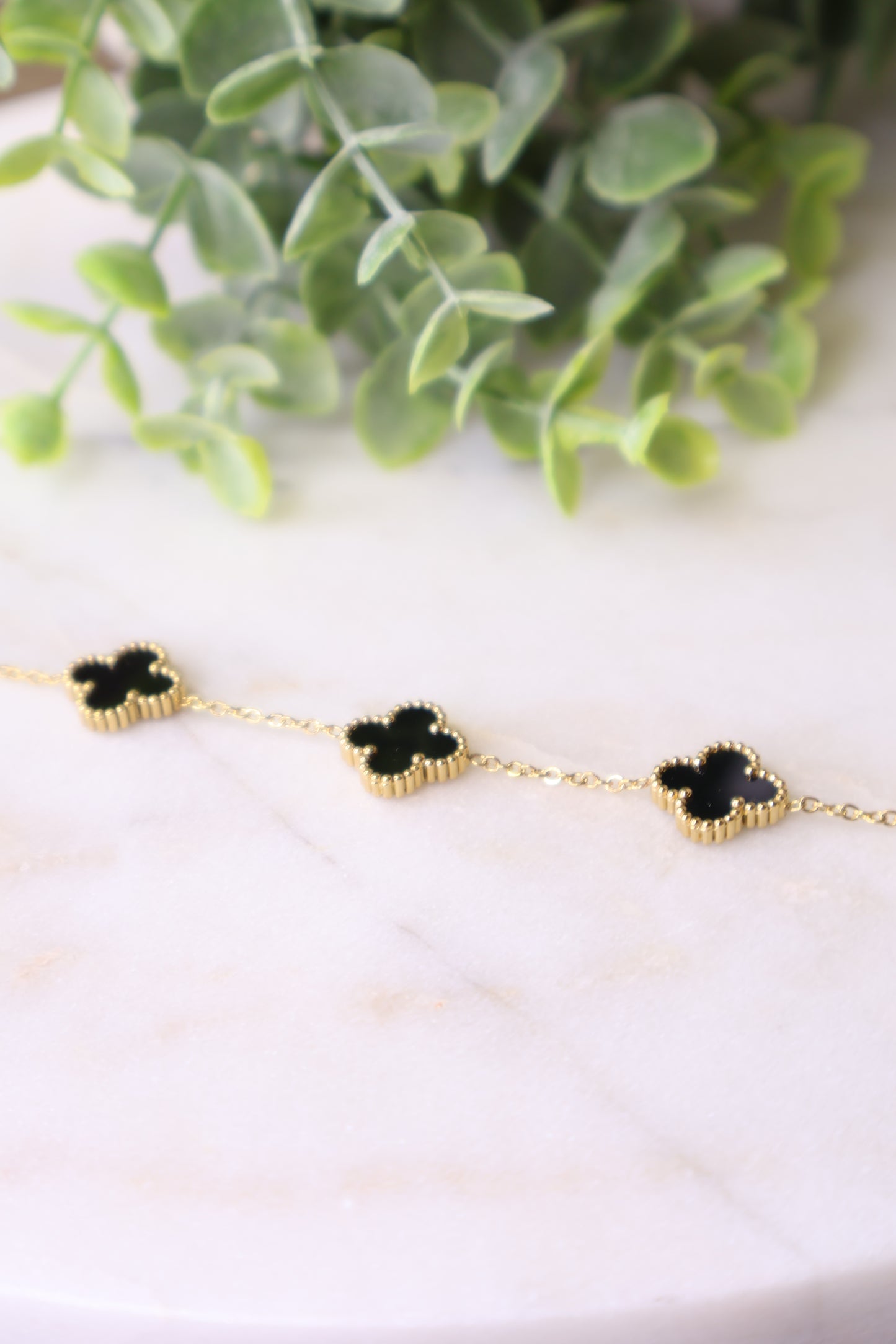 Lucky Luxe: Black & Gold Clover Bracelet