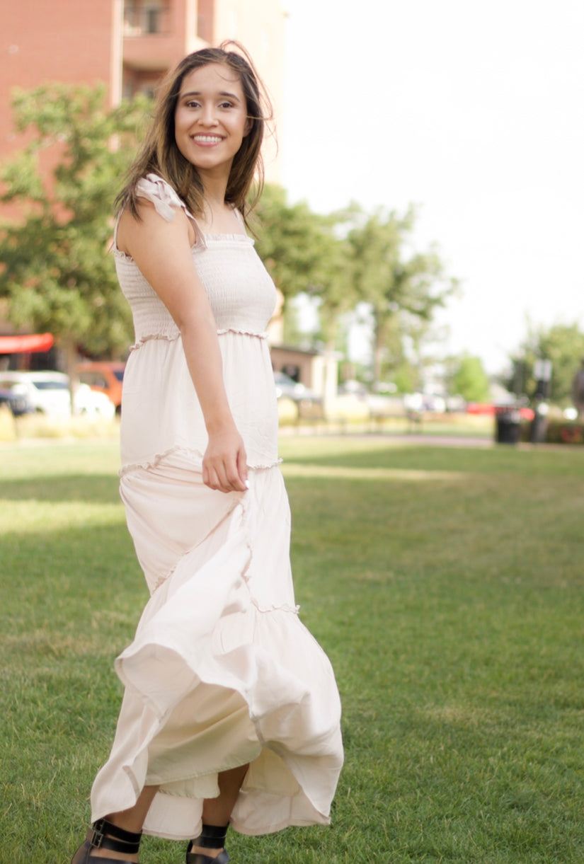 The sweet cream color is such a staple for the new season. It also features a maxi length, smocked bodice, and tiered layers.