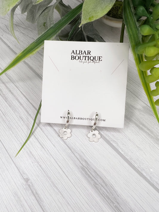 small hoop earrings with a flower charm attached